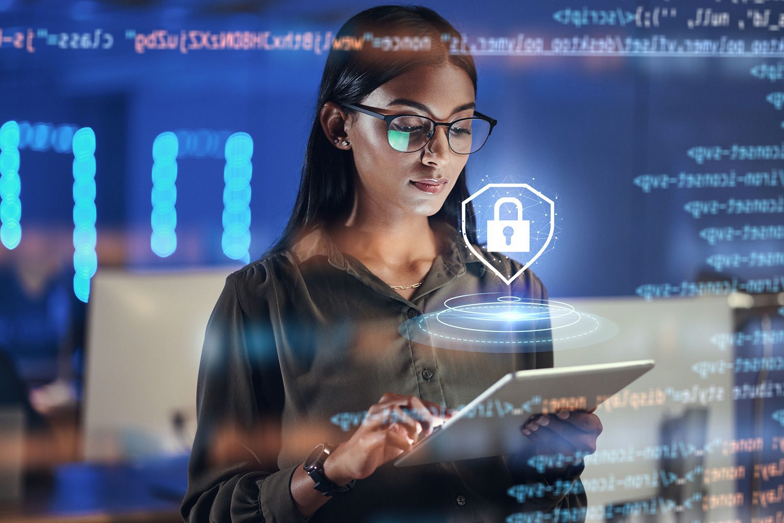 A woman wearing glasses uses a digital tablet in a modern office, with cybersecurity icons and computer code overlaid in the foreground.